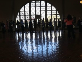 Immigrants arrive at Ellis Island in New York last week for a naturalization ceremony.