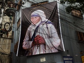 A giant picture of Mother Teresa is displayed outside the Missionaries of Charity Mother house in Kolkata, India, Saturday, Sept. 3, 2016.