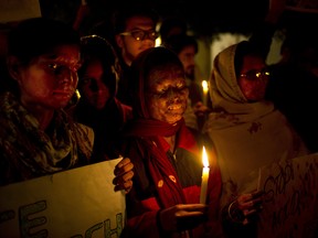 In this Dec. 16, 2014 file photo, acid attack survivors participate in a candlelit vigil protesting violence against women. On Thursday, the first death sentence was given to a man who killed a woman in an acid attack in 2013.