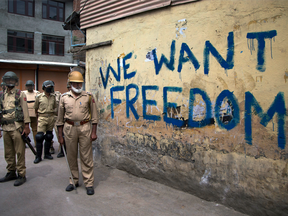 In this Aug. 12, 2016, file photo, Indian policemen stand guard during a curfew in Srinagar, Indian-controlled Kashmir.
