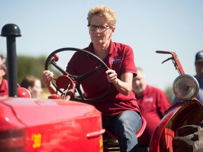 Ontario Premier Kathleen Wynne takes part in a plowing competition during the International Plowing Match in Harriston, Ont.