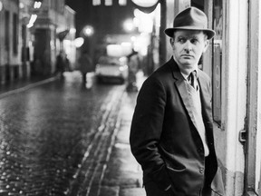 David Cornwell, (a.k.a.  John Le Carré) shown on a dark rainy street in London, February 1964.