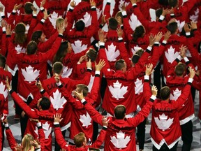 Team Canada athletes wave as they walk into the Maracana during the Rio 2016 opening ceremony on Aug. 5.