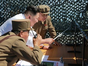 This picture released by North Korea's official Korean Central News Agency shows  leader Kim Jong-Un inspecting the ground jet test of a new type high-power engine of a carrier rocket.