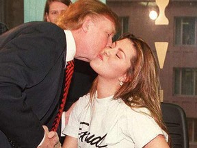 Alicia Machado kisses Donald Trump, owner of the Miss Universe pageant, during her daily fitness workout at a health center in New York in a 1997 file photo.