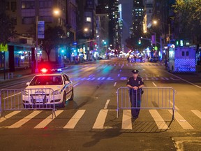 Police stand guard as the cordon Sixth Avenue near the scene of Saturday's explosion on West 23rd Street and Sixth Avenue in Manhattan's Chelsea neighborhood, New York, Sunday, Sept. 18, 2016. An explosion rocked the block of West 23rd Street between Sixth and Seventh Avenues at 8:30 p.m. Saturday. Officials said more than two dozen people were injured. Most of the injuries were minor.
