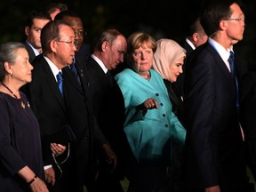 German Chancellor Angela Merkel talks to Russia's President Vladimir Putin as G20 leaders meet on Sept. 4 in China.
