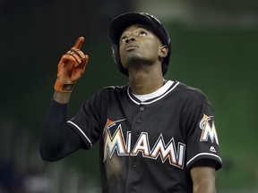 Miami Marlins' Dee Gordon points to the sky after hitting a single during the fourth inning of a baseball game against the New York Mets, Monday, Sept. 26, 2016, in Miami.