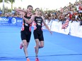 Britain's Alistair Brownlee, left, helps his brother Jonny to get to the finish line during the Triathlon World Series event in Cozumel, Mexico, Sunday Sept. 18, 2016.