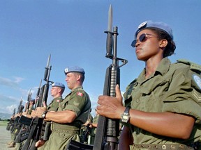 Canadian peacekeepers prepare for a parade at Maple Leaf Camp in Port-au-Prince, Haiti on Nov.28, 1997. The Trudeau government has promised to get Canada back into the peacekeeping business, but a new report from two independent think tanks says the military is ill-prepared for the task.