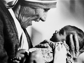 Mother Teresa cradles an armless baby girl at her order's orphanage in Calcutta, India, in 1978.