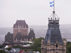 The Quebec flag flies at the province's National Assembly. The Chateau Frontenac hotel is seen in the background.