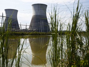 In this Wednesday, Sept. 7, 2016 photo, two cooling towers can be seen in the reflection of a pond outside of the Bellefonte Nuclear Plant, in Hollywood, Al