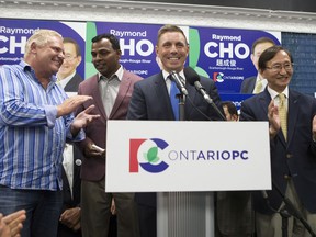 Ontario PC Leader Patrick Brown speaks at the podium to congratulate Raymond Cho, right, as Doug Ford, left, looks on at a campaign victory party to celebrate Cho's election in the Scarborough-Rouge River byelection in Toronto, on Thursday, September 1.