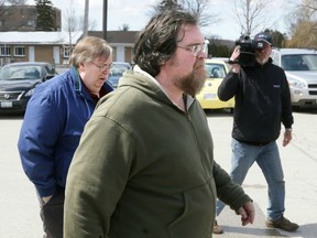 Fred King, centre (in green jacket), and his brother Joseph King, left, (in blue jacket), leave the Ontario Court of Justice following Fred King's bail hearing in Owen Sound on Wednesday, April 16, 2014.