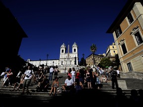 Tourists sit on the Spanish Steps in downtown Rome in this file photo