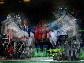 A multiple-exposure photo of Canadian wheelchair fencer Pierre Mainville (left) and Greece's Panagiotis Triantafyllou during a men's individual sabre bout in Rio on Sept. 12.