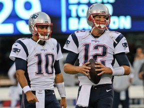 New England Patriots quarterbacks Tom Brady (12) and Jimmy Garoppolo (10) warm up before a pre-season game against the New York Giants on Sept. 1.