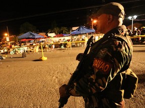 A Philippine soldier keeps watch at a blast site at a night market that has left several people dead and wounded others in southern Davao city, Philippines late Friday Sept. 2, 2016