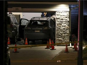 Evidence marked by pylons in the driveway after a shooting on Redstone Manor NE in Calgary, on September 20, 2016.