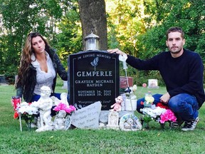 Alisha Tackaberry and Marc Gemperle at the grave of their son, Graysen, at Oakland Cemetery west of Brockville.