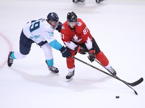 Europe's Roman Josi (left) checks Canada's Sidney Crosby in World Cup round-robin play on Sept. 21.