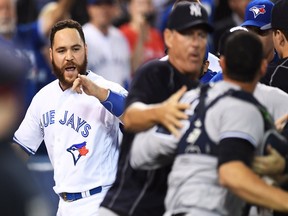 Russell Martin is restrained during Toronto's second-inning brawl with the New York Yankees on Sept. 26.