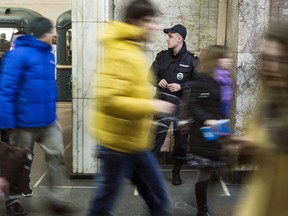 A police officer stands on guard in Moscow's subway, Russia, Thursday, March 24, 2016