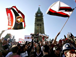 In this May 19, 2007 file photo, Ottawa Senators fans celebrate the team's Eastern Conference final victory over the Buffalo Sabres on Parliament Hill.