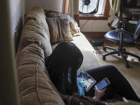 Maureen plays Minecraft and checks messages in her living room, where she was sitting when her principal called her parents to tell them about a nearly naked picture of their daughter that circulated around her middle school.