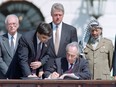 Then-Israeli foreign minister Shimon Peres, centre, signs the Oslo Accords in 1993.