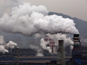 Smoke billows from smokestacks and a coal fired generator at a steel factory on Nov. 19, 2015 in the industrial province of Hebei, China.
