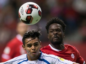 El Salvador's Alexander Larin, left, and Canada's Tosaint Ricketts vie for the ball during second half World Cup qualifying action in Vancouver on Tuesday night.