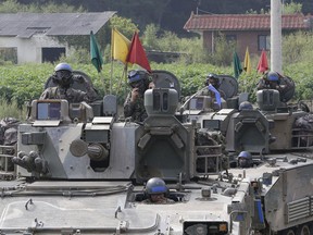 South Korean army soldiers ride their armored vehicles during an annual exercise in Paju, South Korea, near the border with North Korea, Sunday, Sept. 11, 2016.