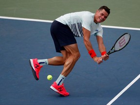 Milos Raonic returns a shot to Ryan Harrison during his second-round loss at the U.S. Open on Aug. 31.