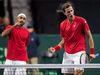 Canada's Vasek Pospisil, right, and Adil Shamasdin react to winning a point against Chile's Nicolas Jarry and Hans Podlipnik-Castillo during Davis Cup tennis World Group playoff doubles action in Halifax on Sept. 17.