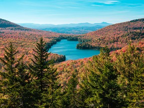 In this October 2014 photo, breathtaking fall foliage in Groton State Forest in Vermont is shown from Owls Head Mountain. Kettle Pond is seen in the distance.