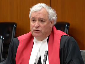 Justice Denny Thomas  delivers his decision in the Travis Vader first-degree murder case on Thursday.