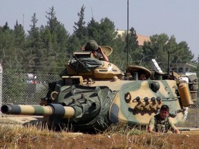 A Turkish army tank stationed near the Syrian border, in Suruc, Turkey, Saturday, Sept. 3, 2016. Turkey's state-run news agency says Turkish tanks have entered Syria's Cobanbey district northeast of Aleppo in a "new phase" of the Euphrates Shield operation. Turkish tanks crossed into Syria Saturday to support Syrian rebels against the Islamic State group, according to the Anadolu news agency.