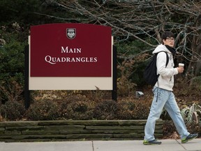 A student walks past an entrance to the University of Chicago.