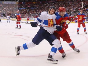 Russian defenceman Dmitry Orlov, right, leans on Finland forward Patrik Laine during the second period of the World Cup of Hockey game at the Air Canada Centre on Thursday afternoon.