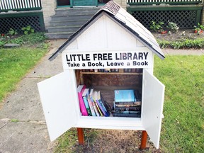 This Little Free Library at the corner of Vansittart Avenue and Brant Street in Woodstock is one of the first in Oxford County, but more Little Libraries are on the way, with many residents building boxes or assembling book collections.  Shown in Woodstock, Ont. on Monday July 13, 2015.