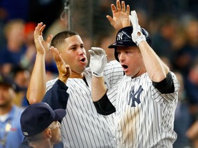 Chase Headley, right, of the New York Yankees, is congratulated by Gary Sanchez after hitting a two-run homerun in the eighth inning of Tuesday's MLB game against the Toronto Blue Jays at Yankee Stadium. The Yankees were 7-6 winners.