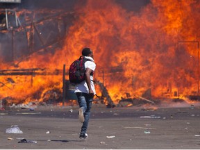 Zimbabwe's opposition supporters erected  a burning barricade in a clash with police during a protest against the Mugabe government in August