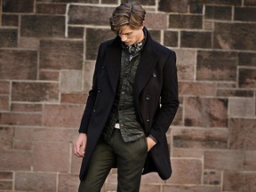 A model wears Club Monaco's Wool Cashmere Topcoat, Quilted CPO Shirt, Slim Dark Floral Shirt, and Sutton Wool Mélange Pant.