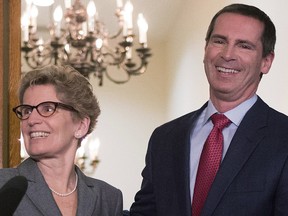 Outgoing Ontario Premier Dalton McGuinty (right) and incoming premier Kathleen Wynne pose for media after a meeting at the Queen's Park in Toronto on Monday, January 28, 2013. THE CANADIAN PRESS/Chris Young ORG XMIT: CHY105 ORG XMIT: POS1301281159352831