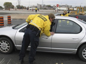 A Canada Customs officer checks a vehicle in a file photo