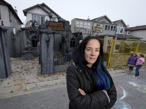 Chrissy Oliver stands outside the elaborate haunted house filling her entire yard