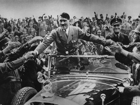 Adolf Hitler, chancellor of Germany, is welcomed by supporters at Nuremberg.
