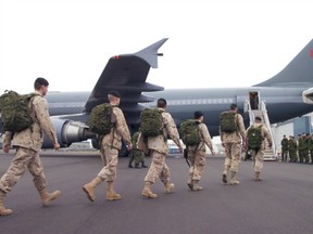 A handful of troops head over to a Canadian Armed forces Airbus aircraft as it boards troops at  the Shell Aerocentre apron area at the Edmonton International Airport in October.